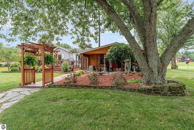 view of front facade featuring a wooden deck, a pergola, and a front lawn