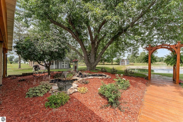 view of yard featuring an outbuilding and a water view