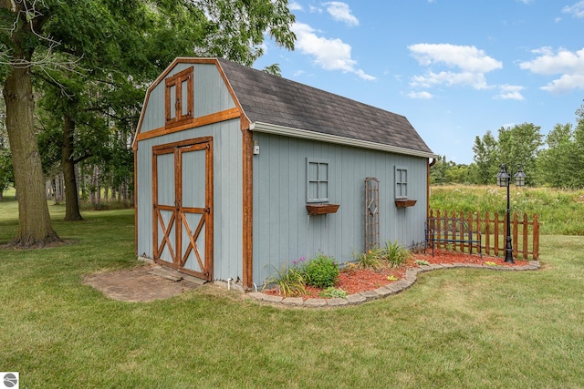 view of outbuilding featuring a yard