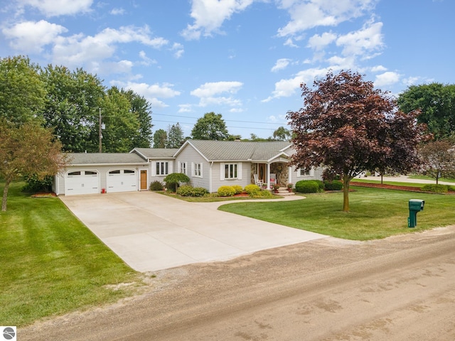 single story home featuring a garage and a front lawn