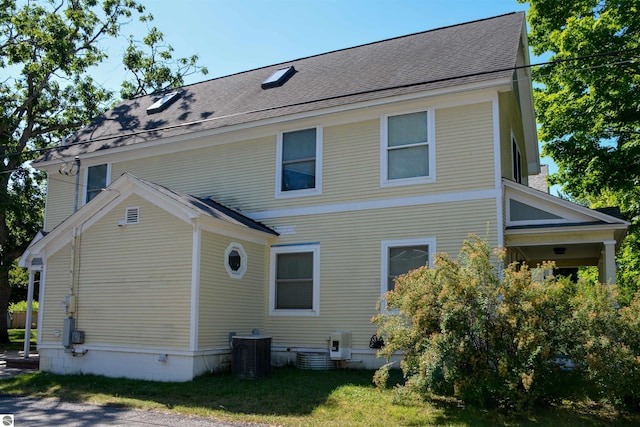 back of house with central air condition unit