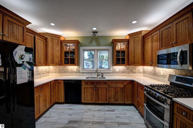 kitchen with tasteful backsplash, crown molding, sink, and black appliances