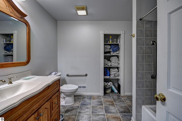 full bathroom with vanity, toilet, and tiled shower / bath combo