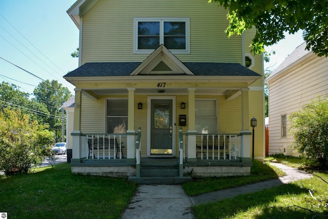 view of front facade with a porch and a front lawn