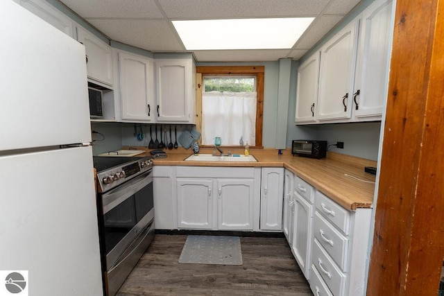 kitchen featuring sink, a paneled ceiling, electric range, white cabinets, and white fridge