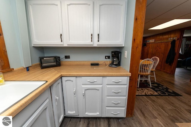 kitchen featuring white cabinetry, dark hardwood / wood-style floors, and sink