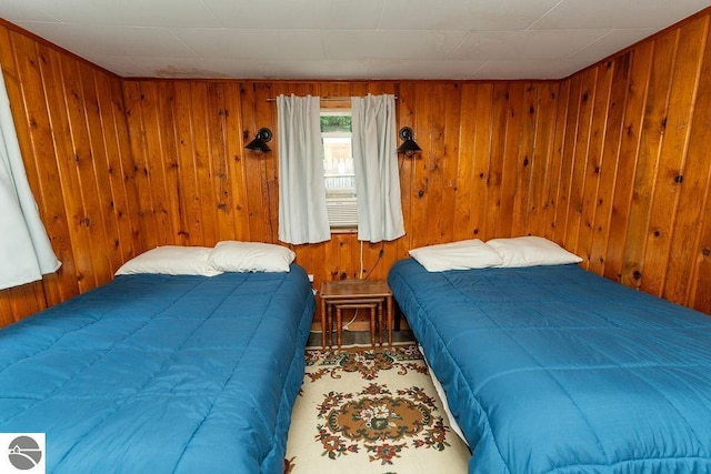 bedroom featuring wooden walls