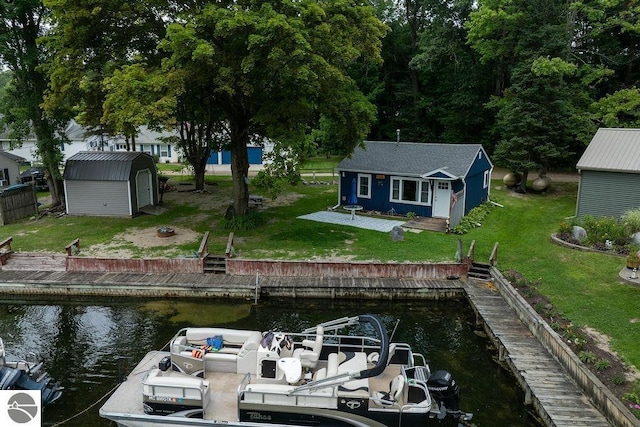 view of dock featuring a yard and a water view