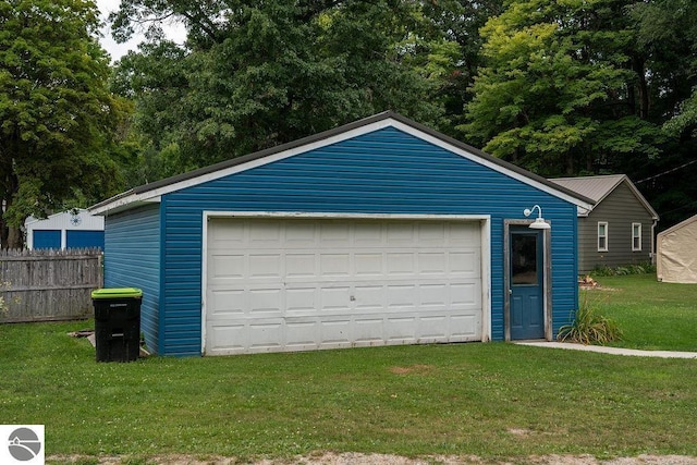 garage featuring a lawn