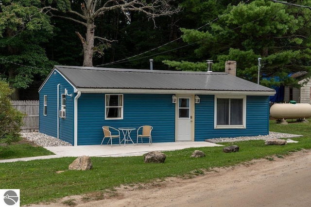 exterior space with cooling unit and a front lawn