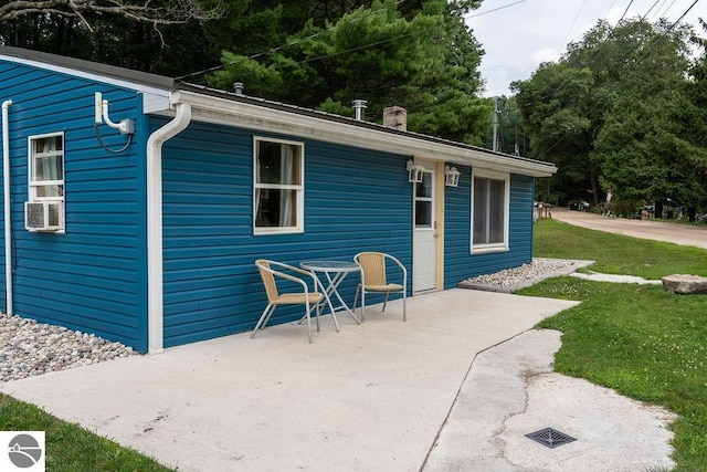 view of outdoor structure featuring cooling unit and a lawn