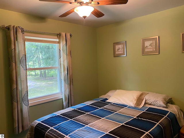 bedroom with multiple windows and ceiling fan