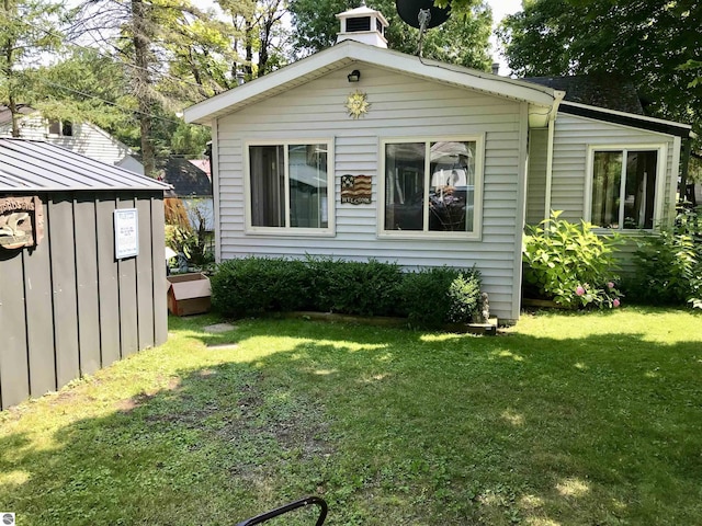 exterior space featuring an outbuilding and a lawn