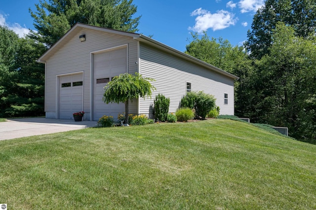 view of home's exterior featuring a yard, an outdoor structure, and a garage