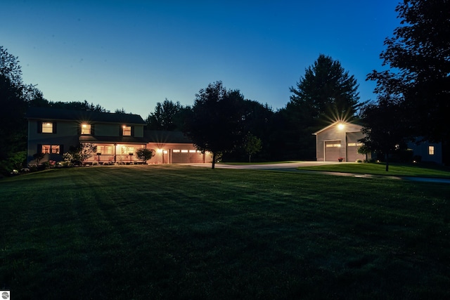 yard at dusk featuring a garage