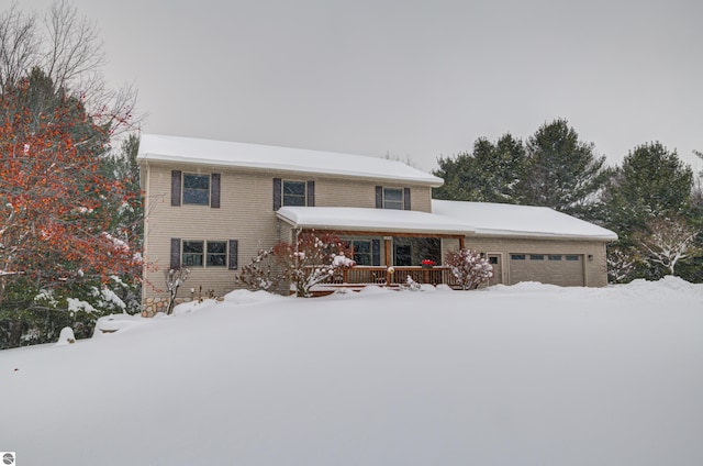 view of front property featuring a garage and a porch