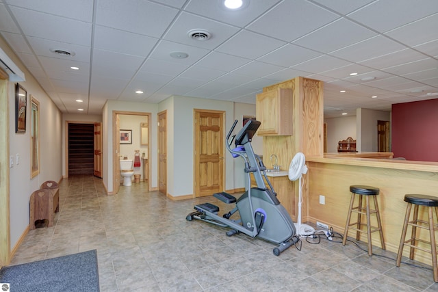 exercise room featuring a paneled ceiling