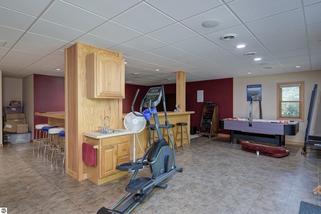 interior space with sink and a drop ceiling