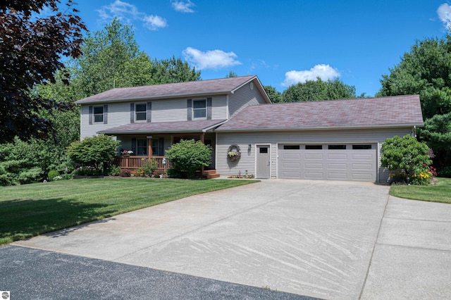 view of property featuring a garage, a front yard, and a porch