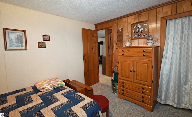 carpeted bedroom with a textured ceiling