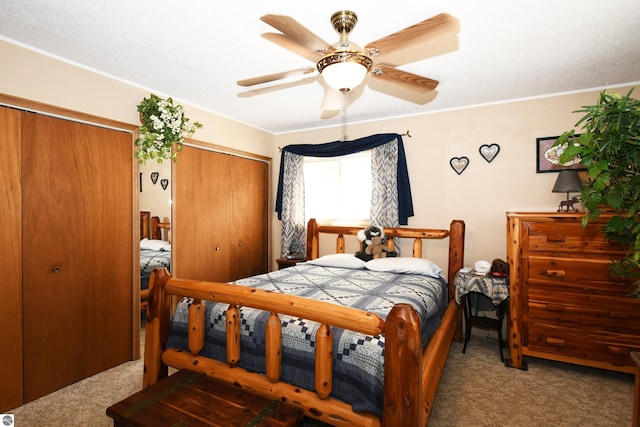 bedroom featuring multiple closets, ceiling fan, and carpet flooring