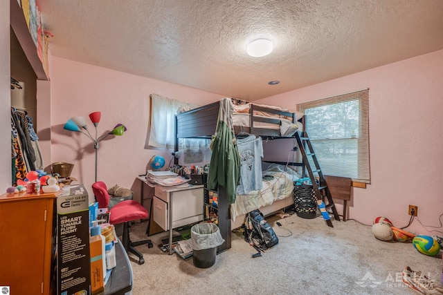 carpeted bedroom with a textured ceiling and a textured wall