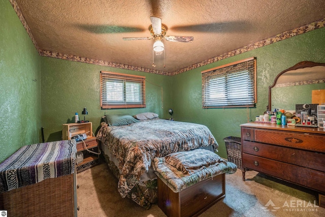 carpeted bedroom with a textured ceiling, a textured wall, and ceiling fan