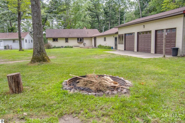 view of yard with driveway and an attached garage