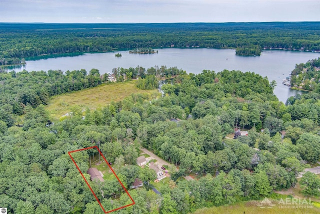 birds eye view of property with a water view and a wooded view