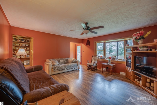 living room with ceiling fan and wood finished floors