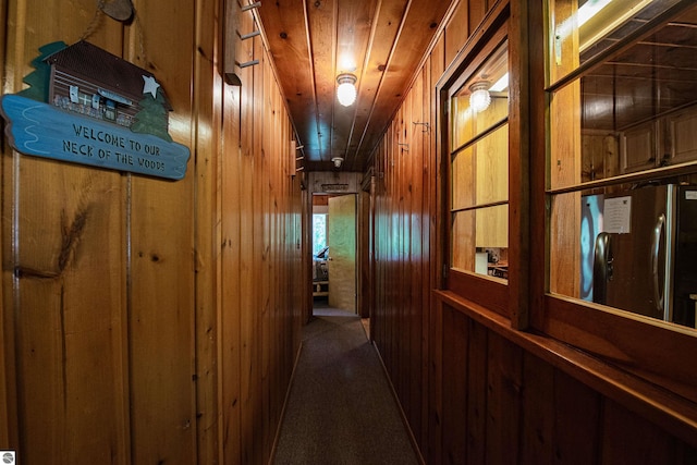 hall featuring wood walls