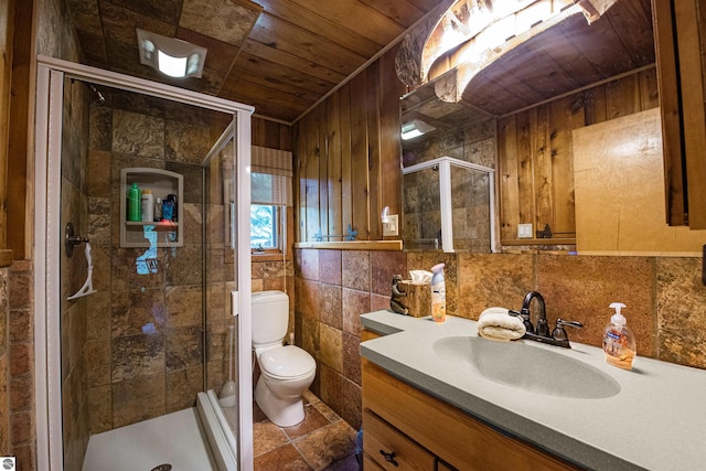 bathroom featuring wooden ceiling, toilet, a shower with door, tile walls, and vanity