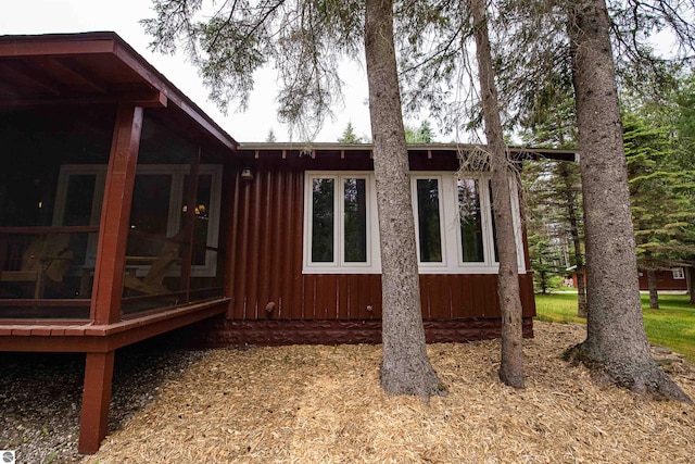 view of side of property with a sunroom