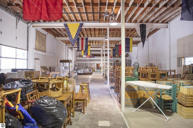 interior space featuring a garage, unfinished concrete floors, and a workshop area