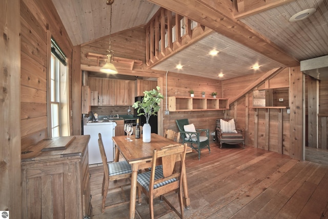 dining space with vaulted ceiling with beams, wood ceiling, and wooden walls