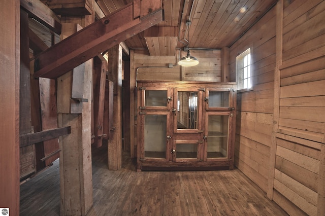 interior space featuring wood ceiling, wood-type flooring, and wooden walls