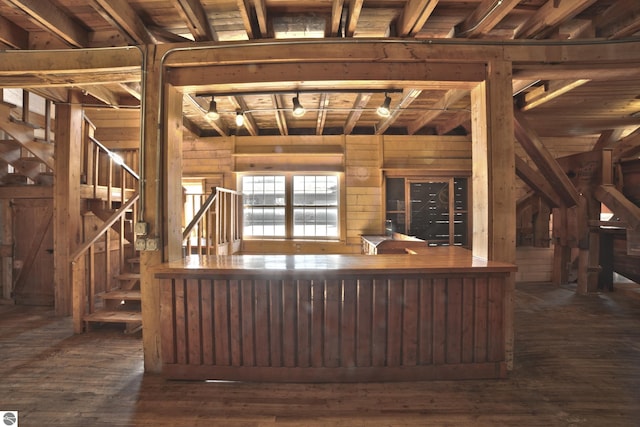 interior space featuring wood walls, hardwood / wood-style floors, and stairs