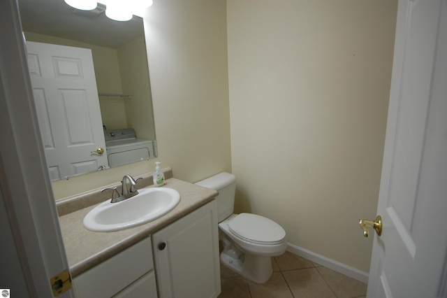 bathroom with washer / clothes dryer, vanity, tile patterned flooring, and toilet