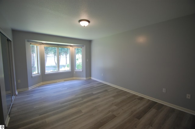 unfurnished room featuring hardwood / wood-style floors