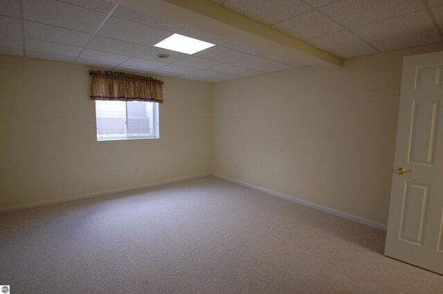 unfurnished room featuring a drop ceiling and carpet floors