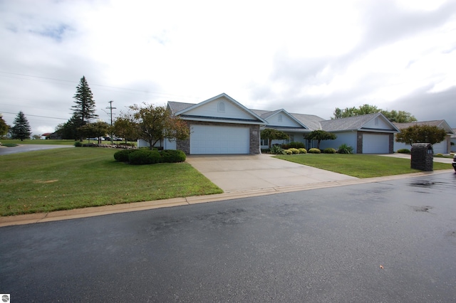 ranch-style home featuring a front lawn and a garage