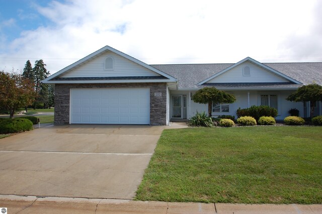 ranch-style home with a garage and a front yard