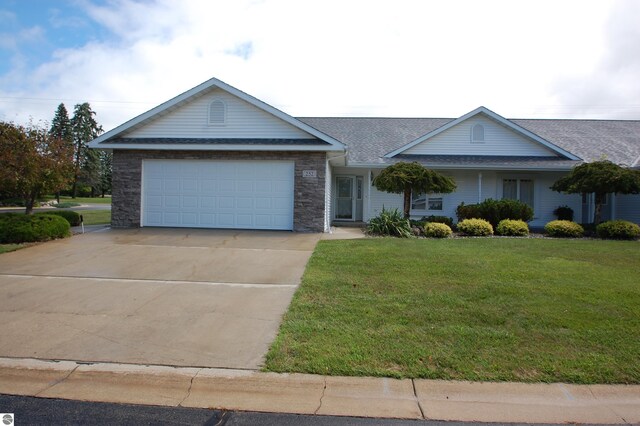 ranch-style house featuring a front lawn and a garage