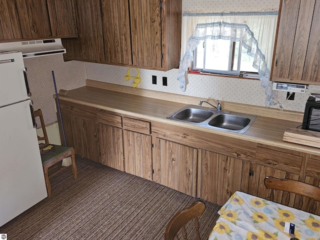 kitchen with sink and white fridge