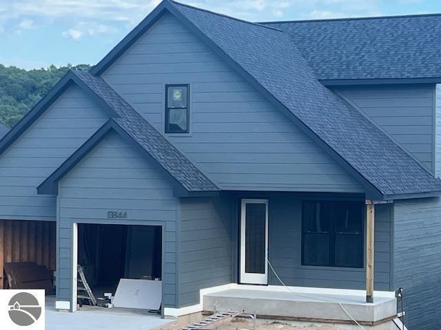 view of front of house with a shingled roof