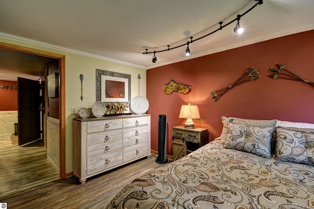 bedroom with crown molding and dark wood-type flooring