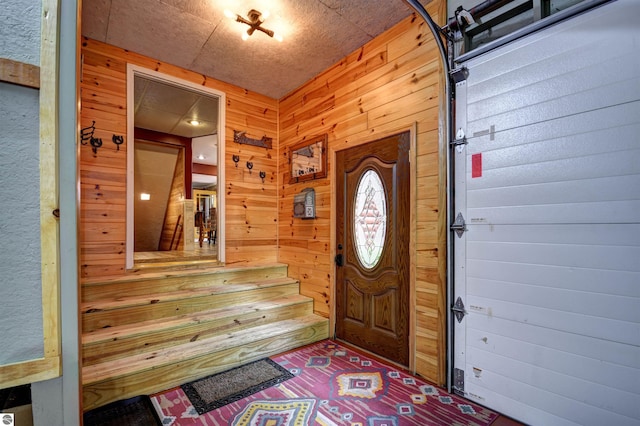 foyer entrance featuring wooden walls