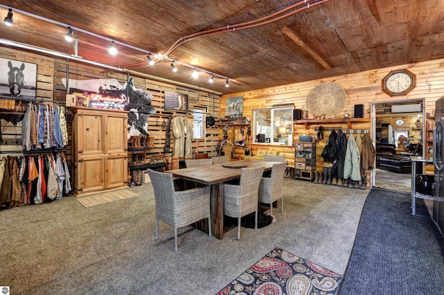 dining area with rail lighting, carpet, and wood ceiling