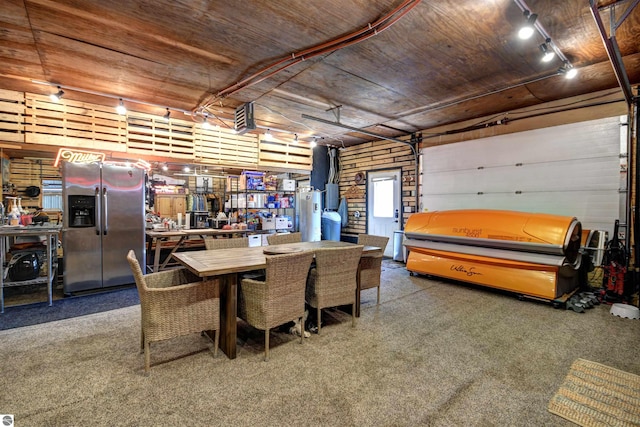 dining space featuring wood ceiling and a workshop area