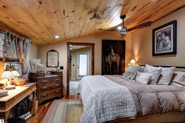 bedroom with vaulted ceiling, hardwood / wood-style floors, and wooden ceiling